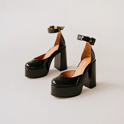 High heels and platforms in black patent leather